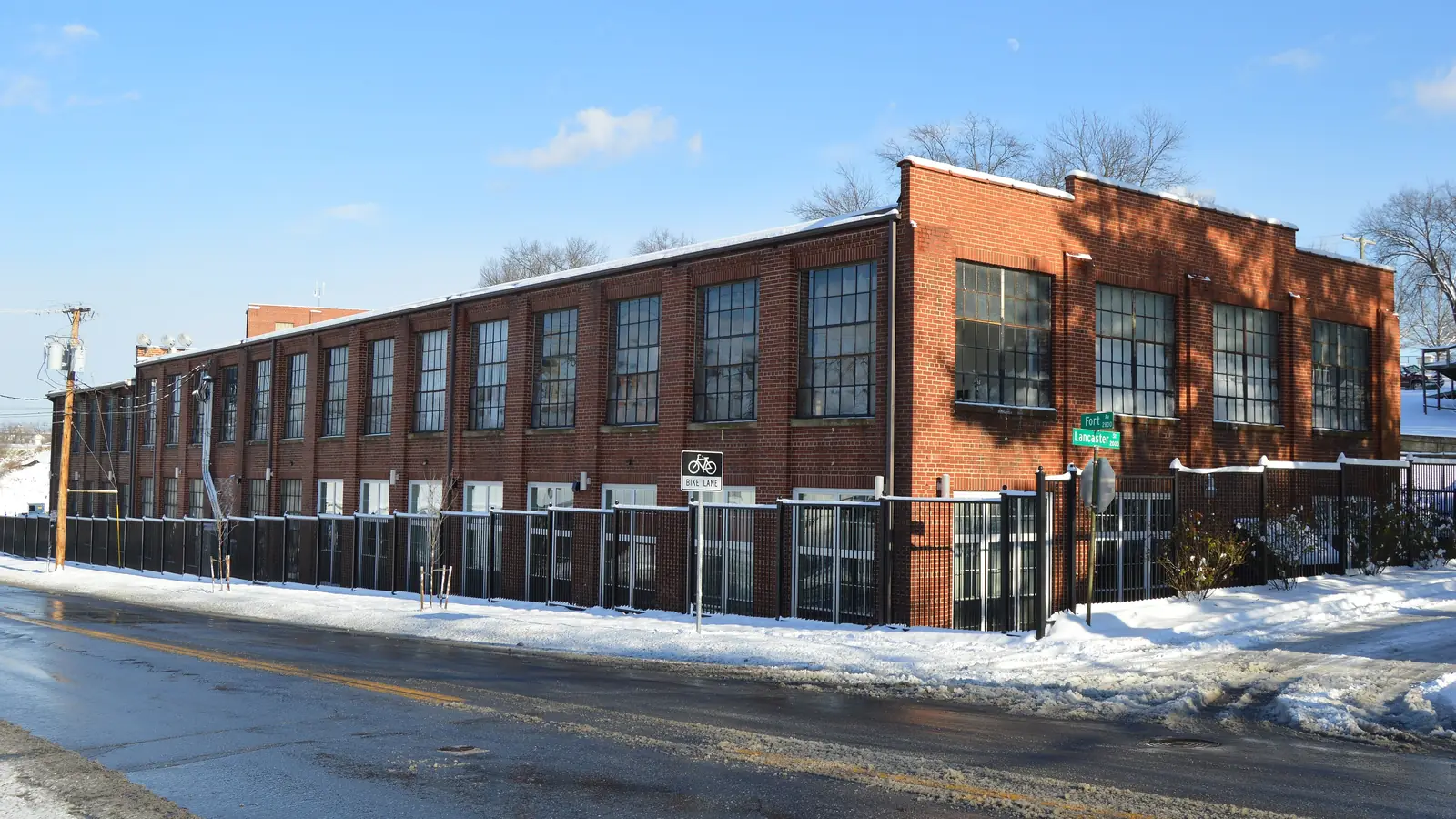 The long red-brick mill building of the Lynchburg Hosiery Mill No. 1 on a snowy winter day in Lynchburg, Virginia