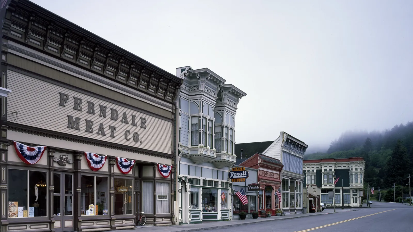 Row of restored Victorian-era shop buildings along the main street of a small California town